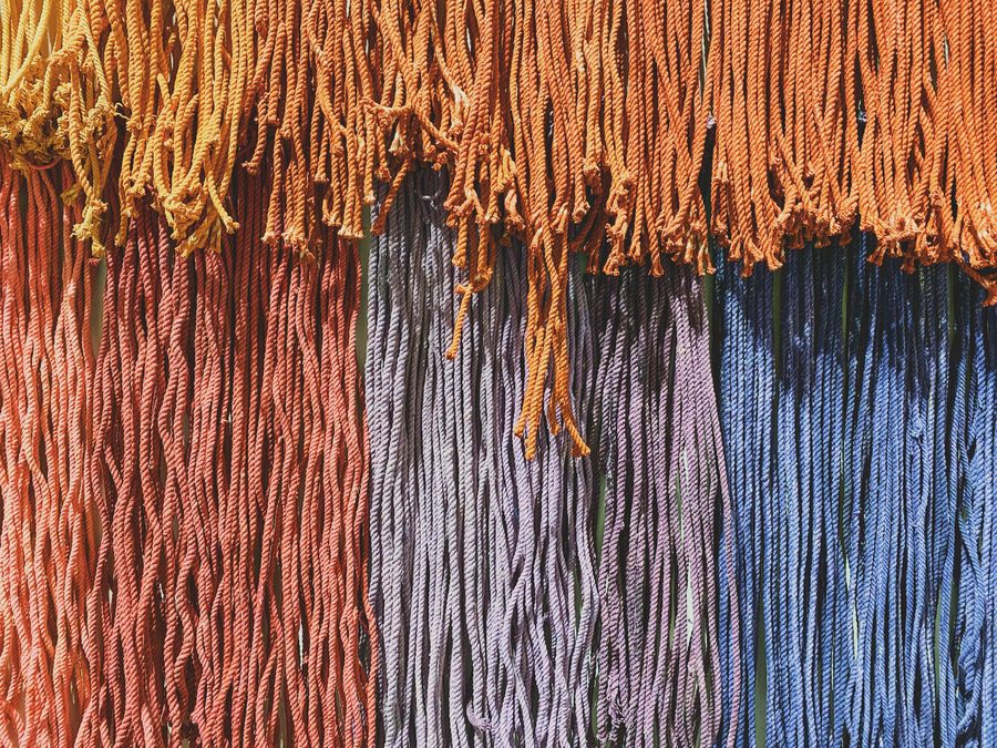 Hundreds of colourful threads in an art installation.