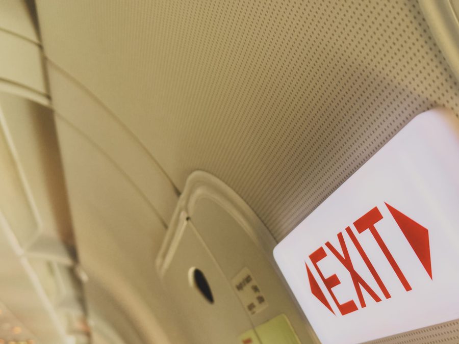An exit sign on a plane.