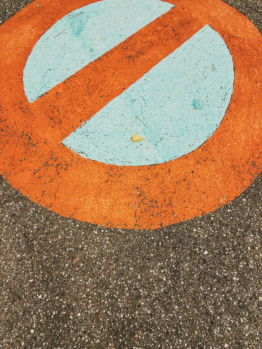 A “do not park” sign painted on the road.