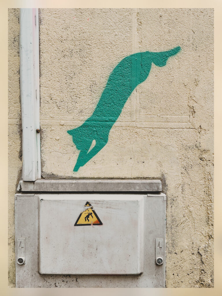 A mural of a cat jumping in an electrical junction box.
