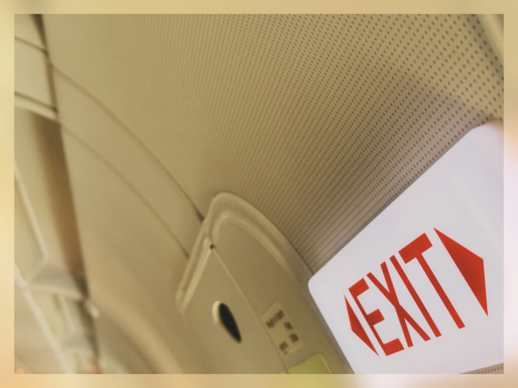 An exit sign in a plane.