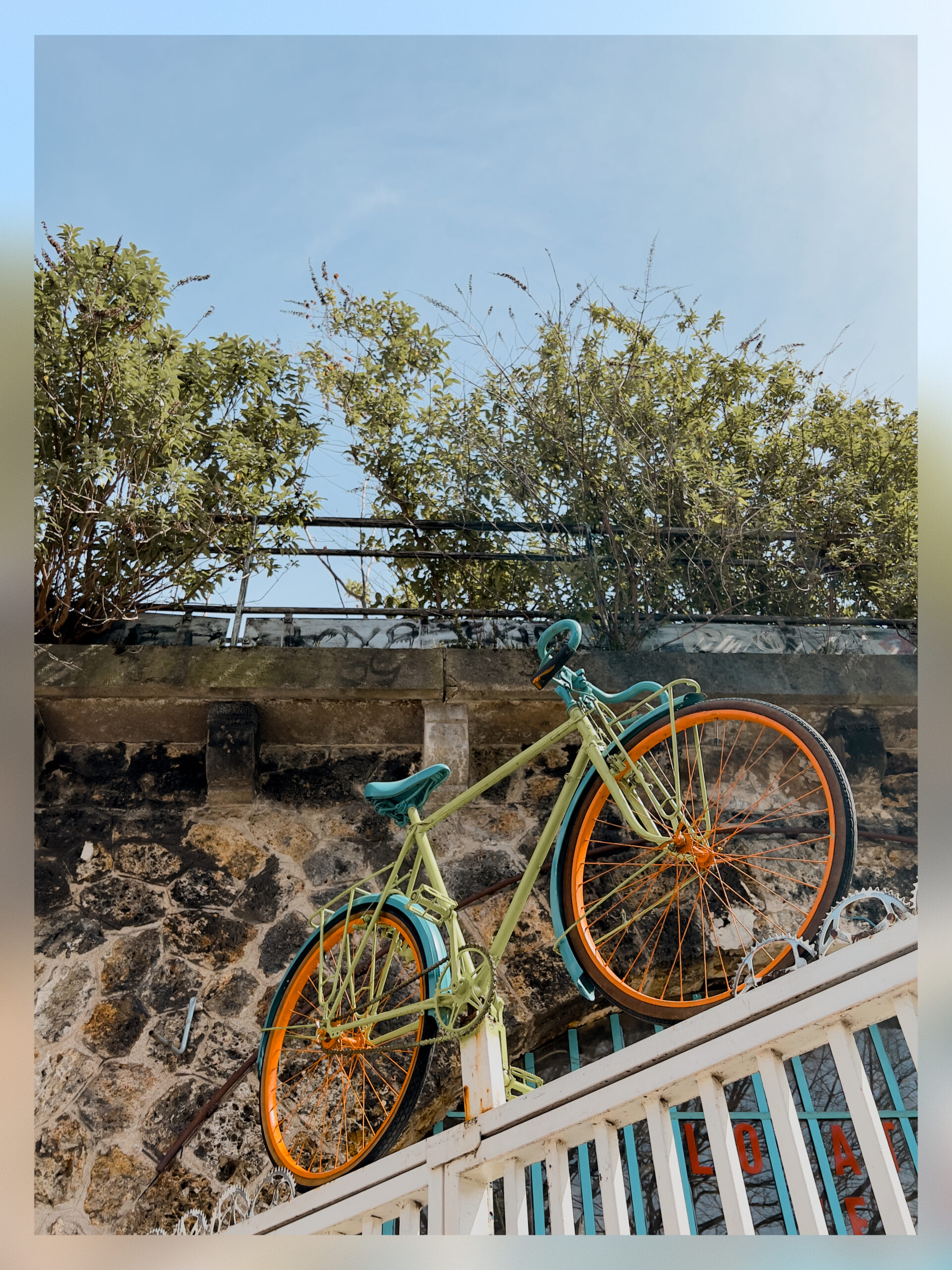 A bike on top of the entrance grid of a bike shop.