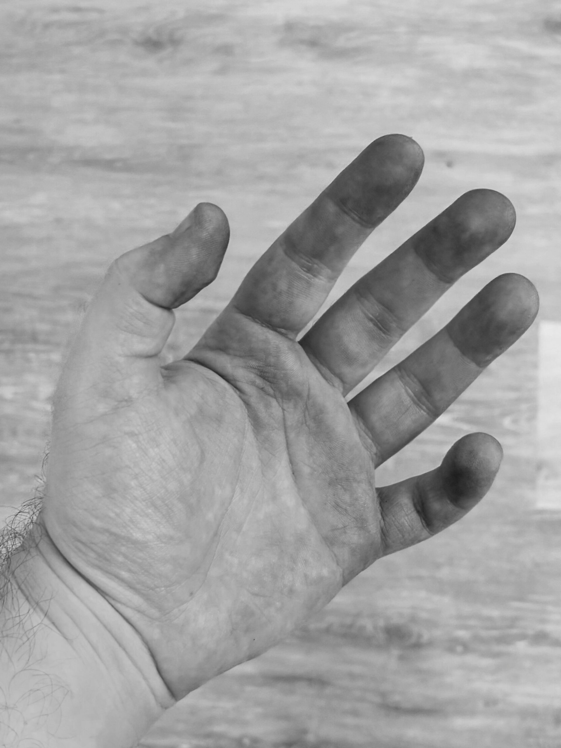 A hand covered in metal powder.