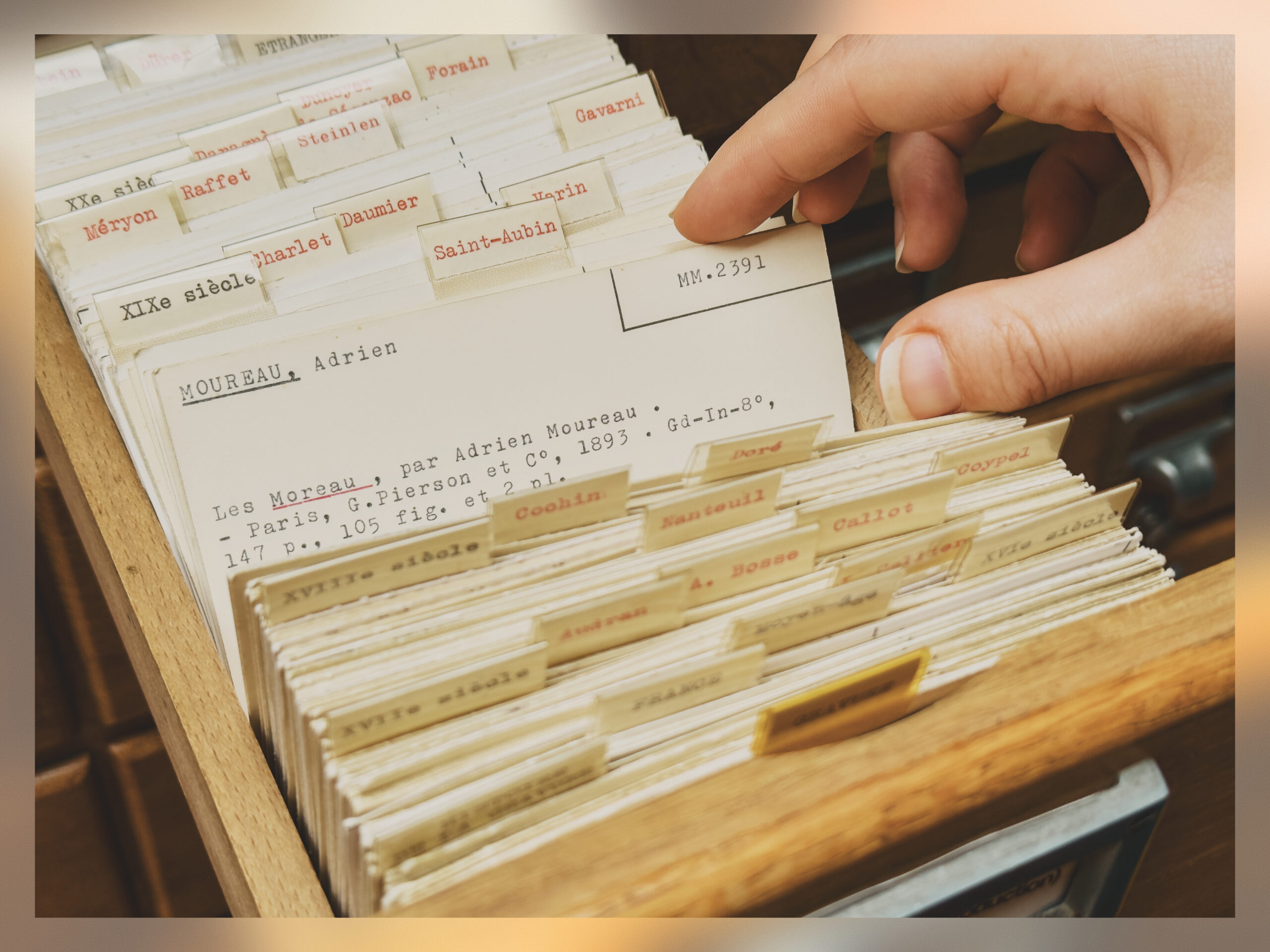 A person sifting through a card catalog.