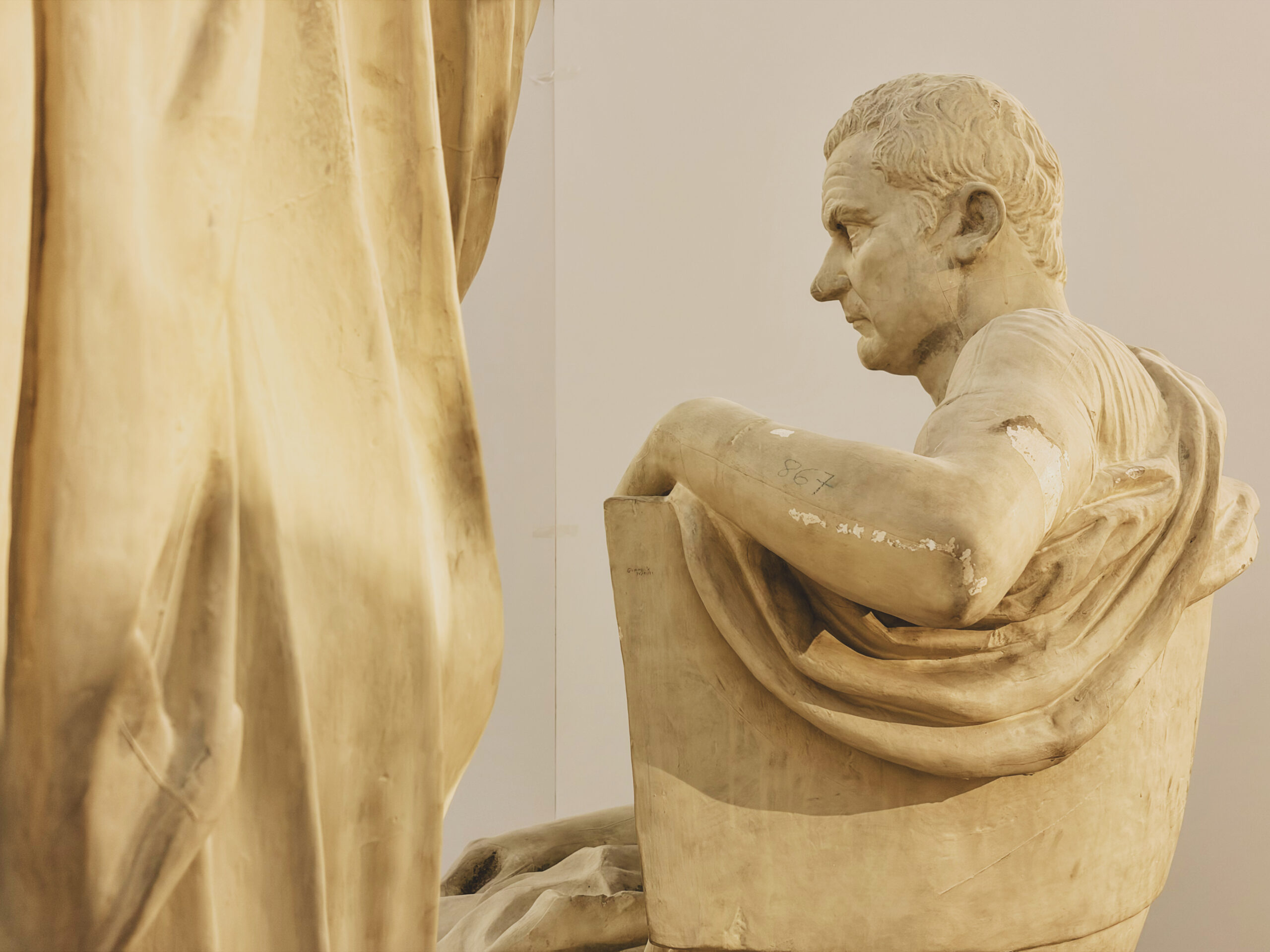 A sculpture of a Roman poet viewed from the side.
