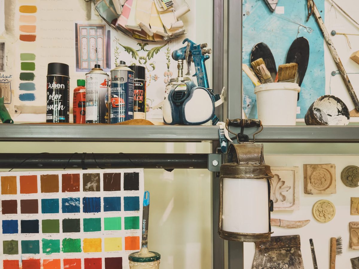 An assortment of colour swatches and paints on shelves.